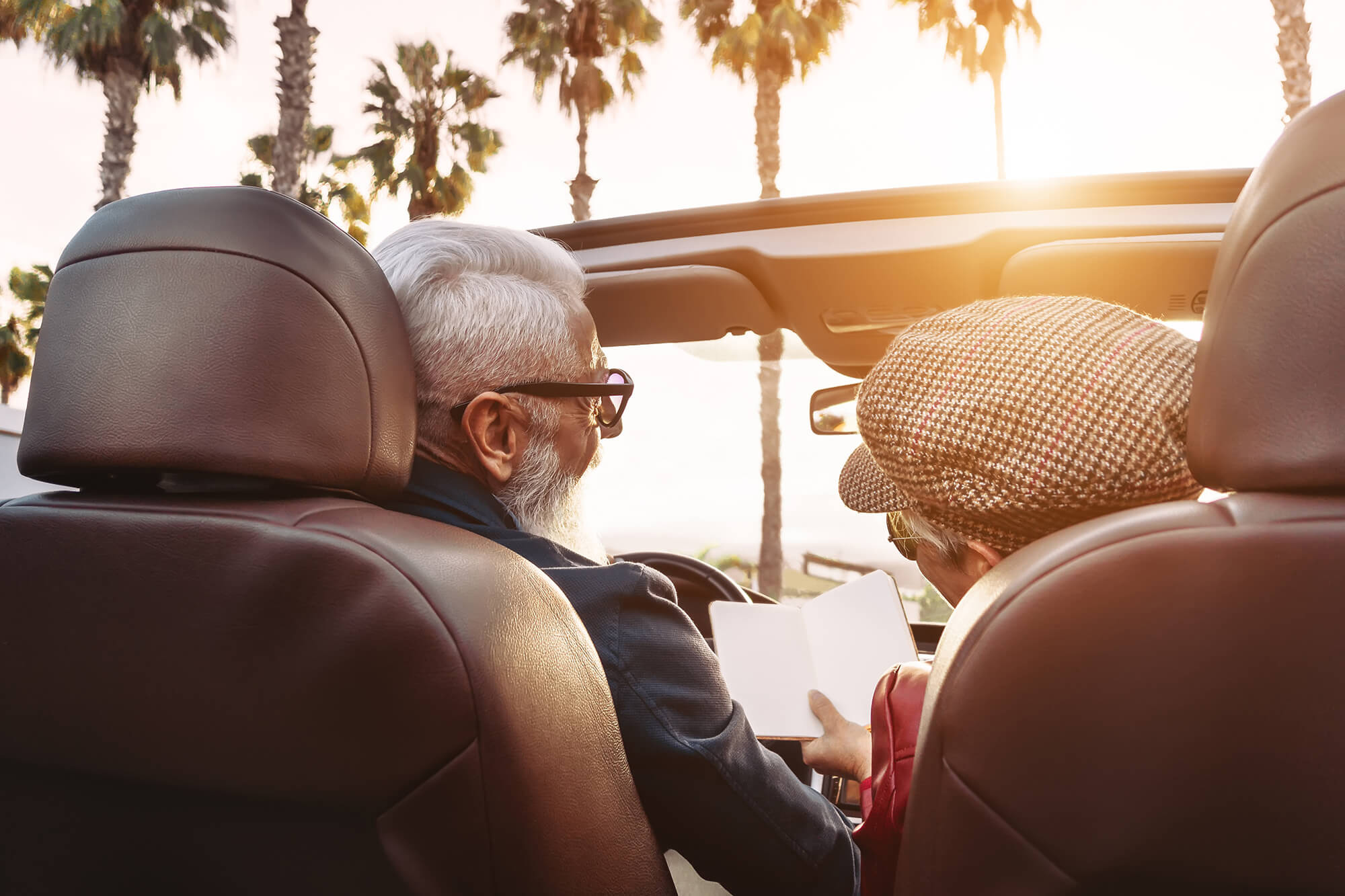 Happy senior couple having fun on new convertible car